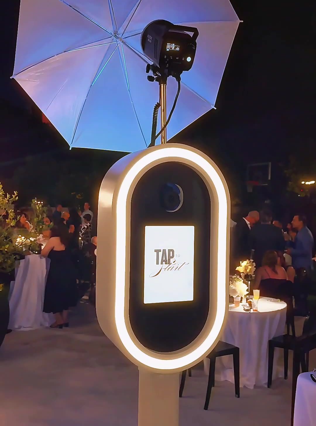 LA Glam Booth Glam Booth with a lit oval frame and studio light at an evening backyard party