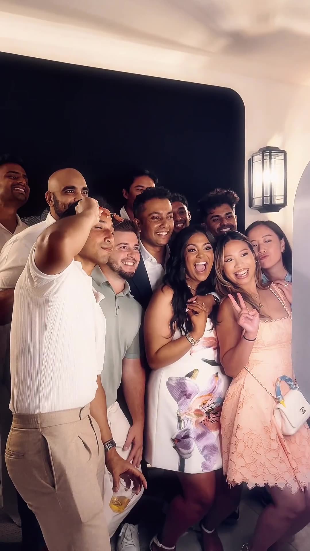 Friends crowd into the Glam Booth at an engagement party in Beverly Hills