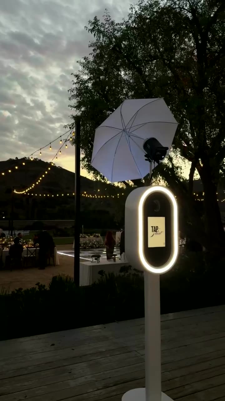 Guests at an LA Glam Booth Glam Booth during a wedding reception at golden hour