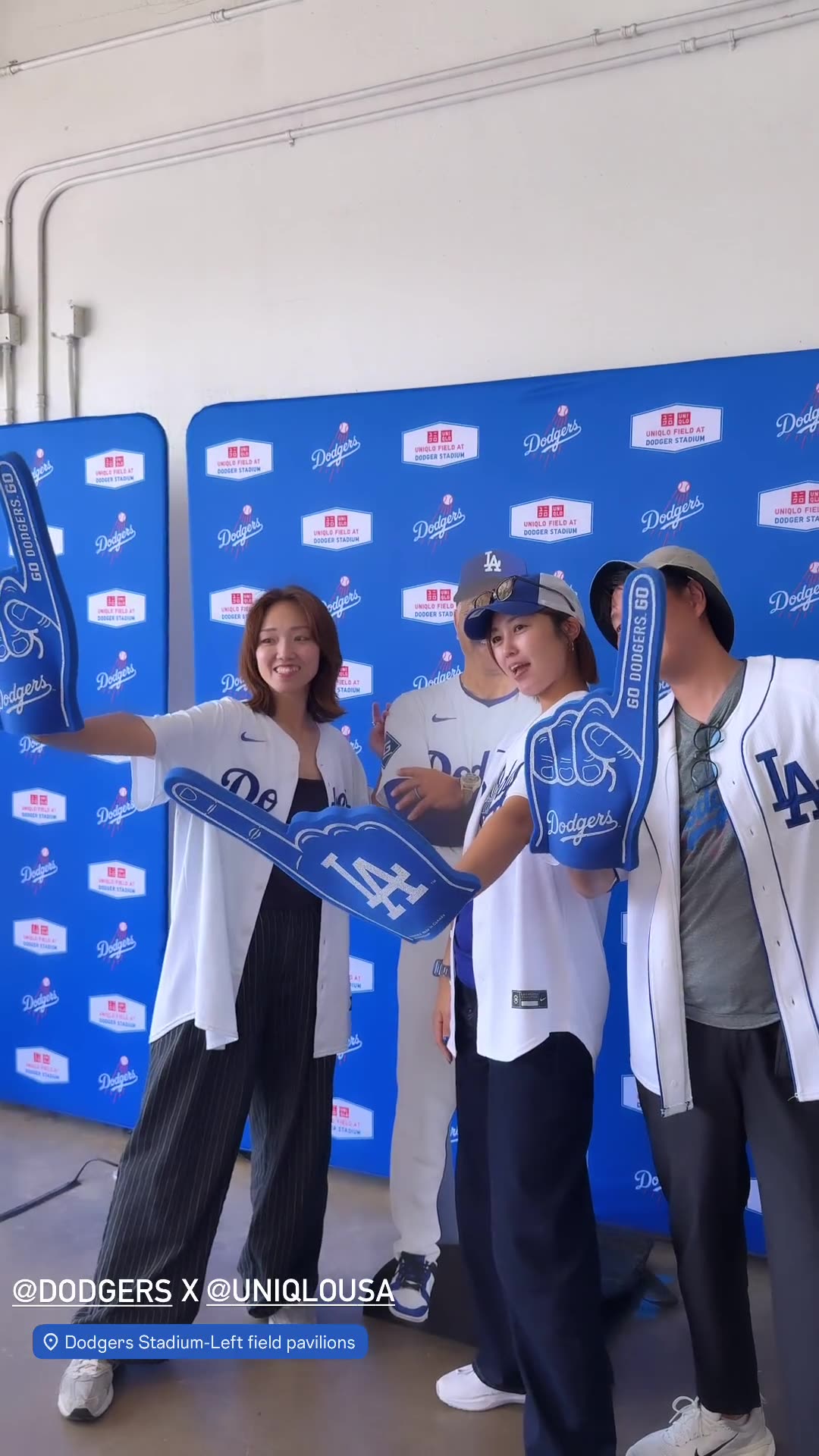 Fans posing at the UNIQLO-wrapped Mochi Booth by LA Glam Booth at Dodger Stadium